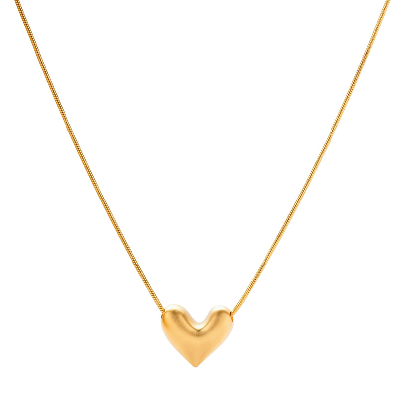 Dainty 18K gold-plated sterling silver necklace with small heart pendant on delicate chain against cream background.