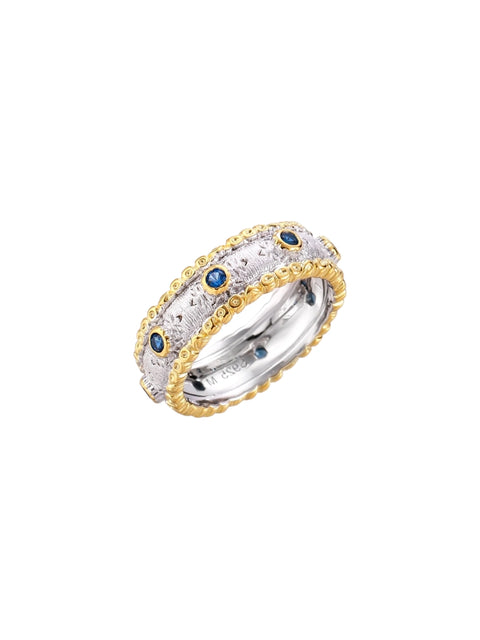Two-tone ring with brushed silver center, gold beaded edges, and blue zirconia stones on white background.