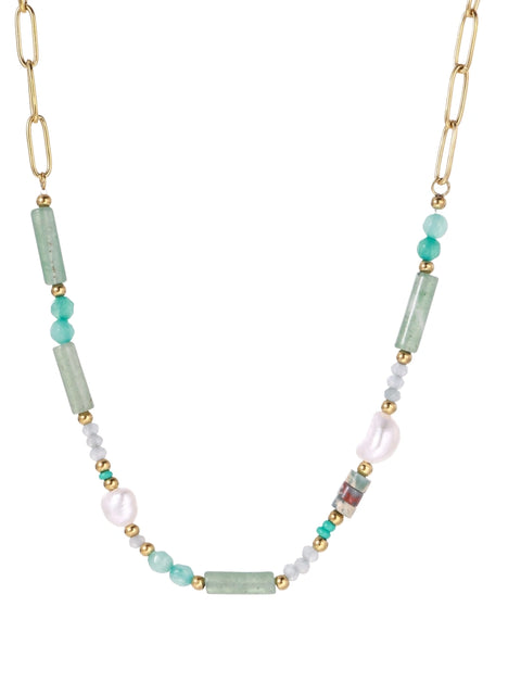 Gold chain necklace with seafoam green quartz cylinders, turquoise beads, and baroque pearl on cream background