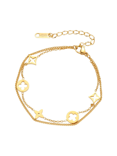 Double-layer gold-plated bracelet with quatrefoil and star charms on cream background, 18K gold finish.