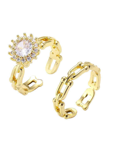 Two adjustable gold rings: chain-link band and halo-style ring with cubic zirconia stones on cream background